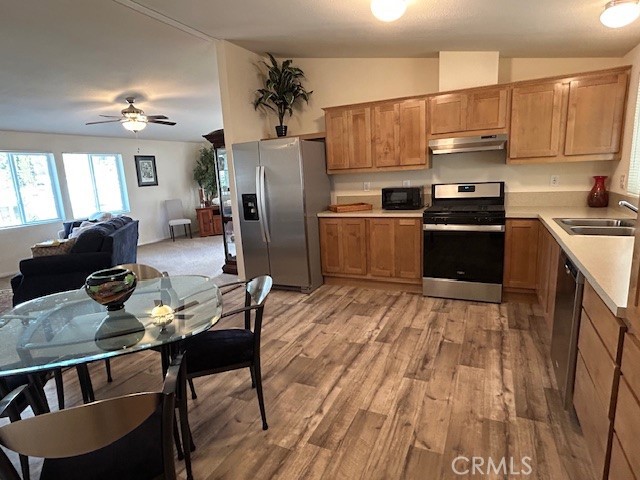 1340 Bille Road, Unit 13 Paradise, CA 95969 - Photo 12 of 31 a kitchen with stainless steel appliances kitchen island granite countertop a refrigerator a stove a sink dishwasher with a dining table and chairs