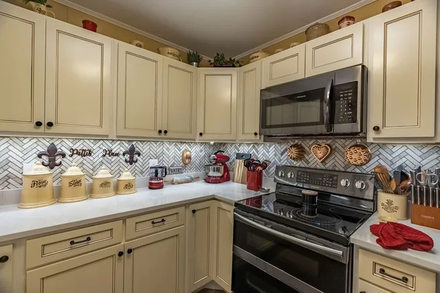 a kitchen with a stove and a microwave
