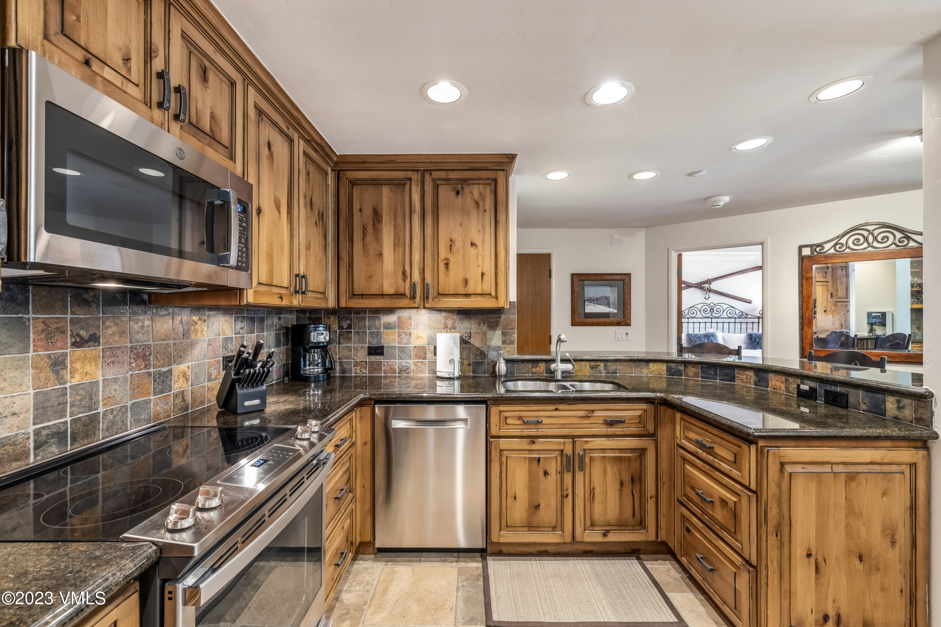 120 Offerson Road, Unit D260 Beaver Creek, CO 81620 - Photo 12 of 41 a kitchen with stainless steel appliances granite countertop a stove and a sink