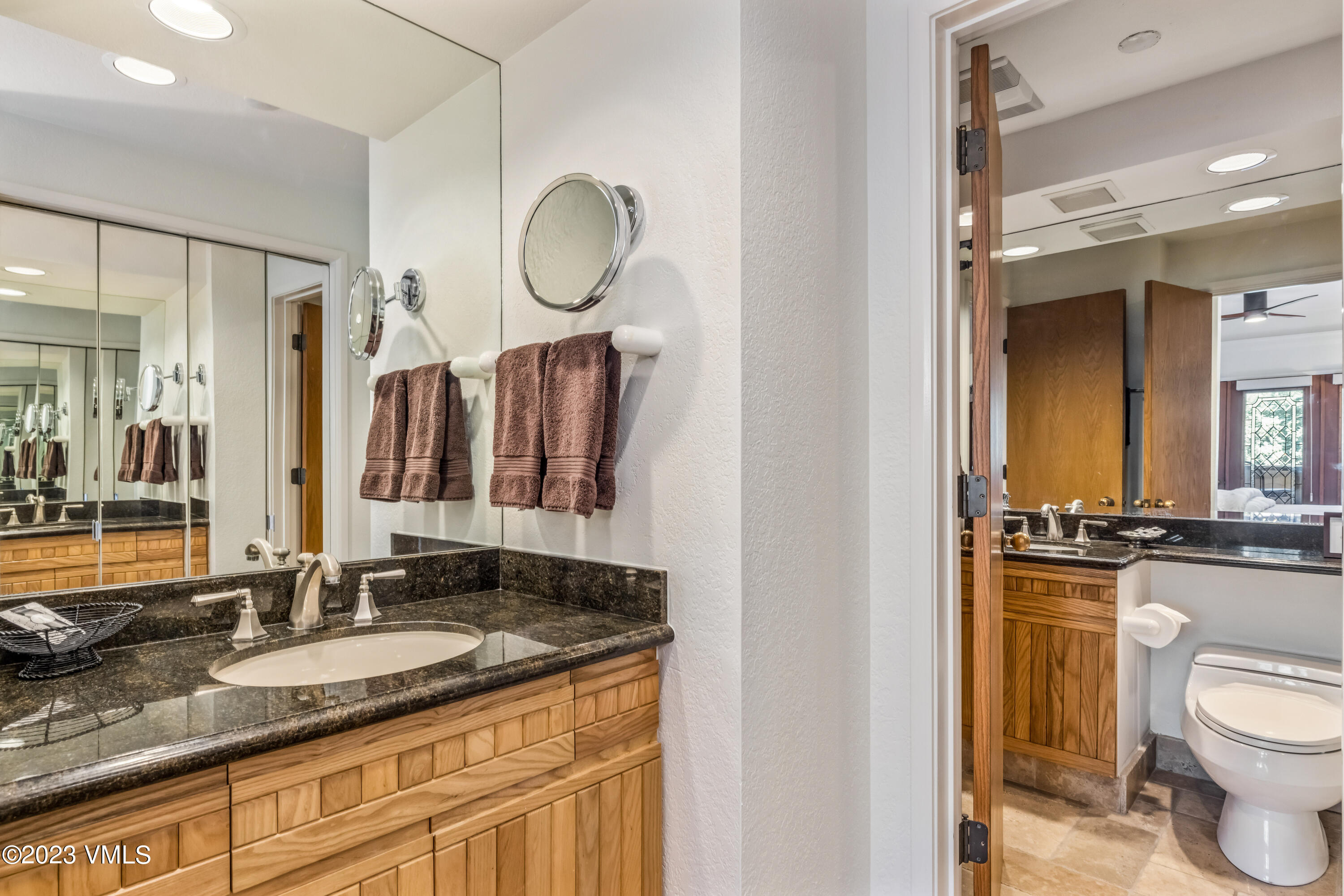 120 Offerson Road, Unit D260 Beaver Creek, CO 81620 - Photo 20 of 41 a bathroom with a granite countertop sink a toilet a mirror and a shower