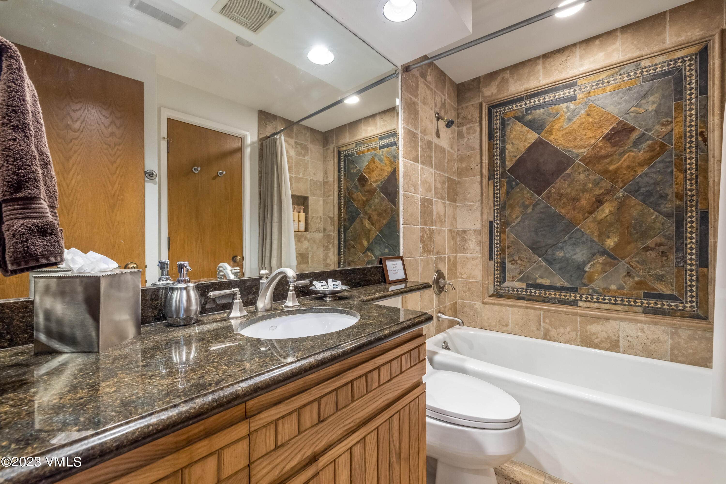120 Offerson Road, Unit D260 Beaver Creek, CO 81620 - Photo 21 of 41 a bathroom with a granite countertop tub sink toilet and mirror