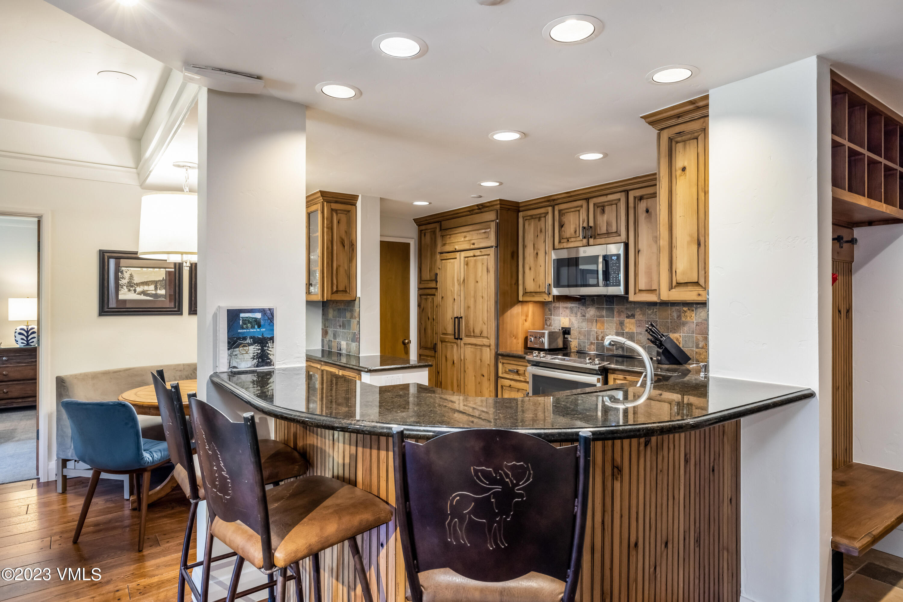 120 Offerson Road, Unit D260 Beaver Creek, CO 81620 - Photo 9 of 41 a kitchen with a table chairs stove and cabinets
