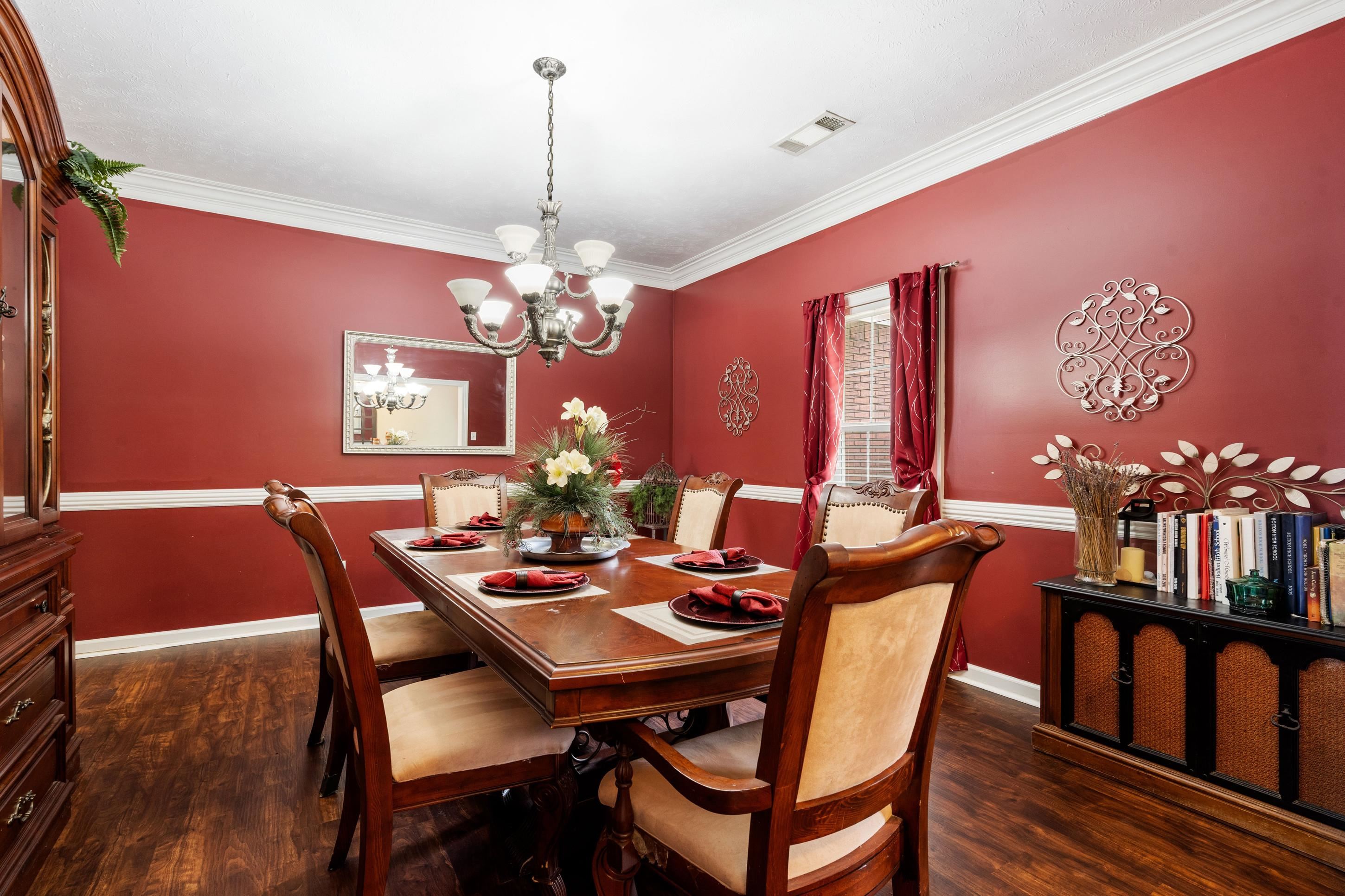 7757 Brunswick Road Millington, TN 38053 - Photo 8 of 40 Dining area featuring wood-finish flooring, a white crown molding and chair rail, and a multi-bulb chandelier