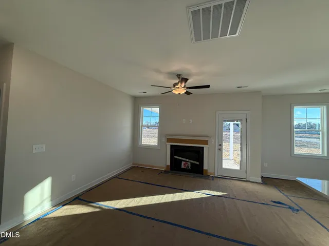 a view of empty room with a fireplace