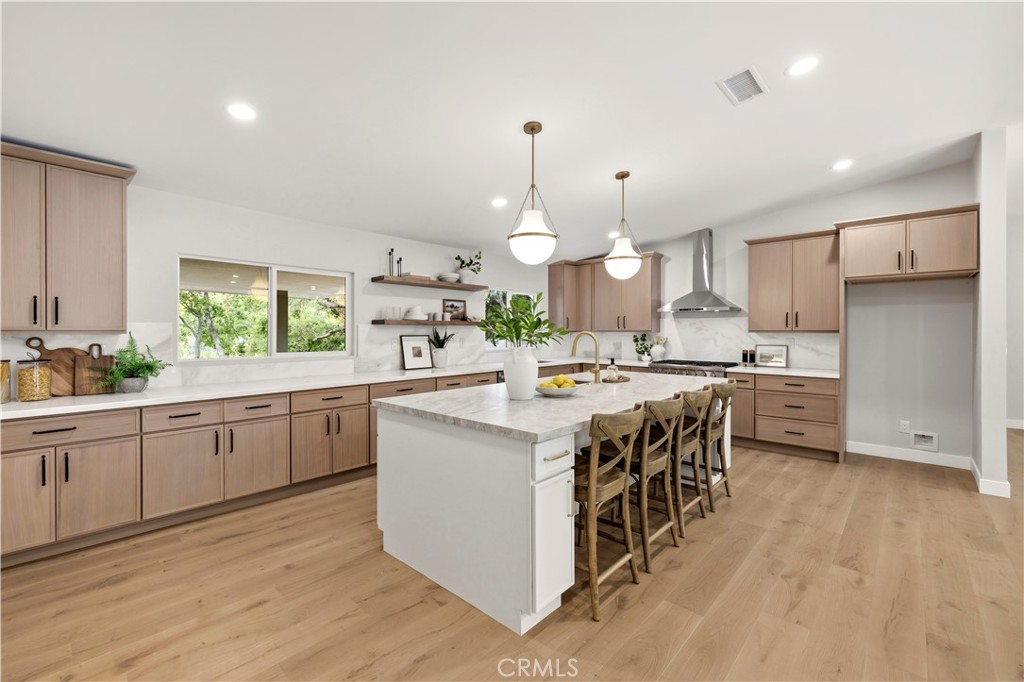 26418 Sand Canyon Road Canyon Country, CA 91387 - Photo 14 of 70 a kitchen with kitchen island granite countertop a sink a counter top space stainless steel appliances and cabinets