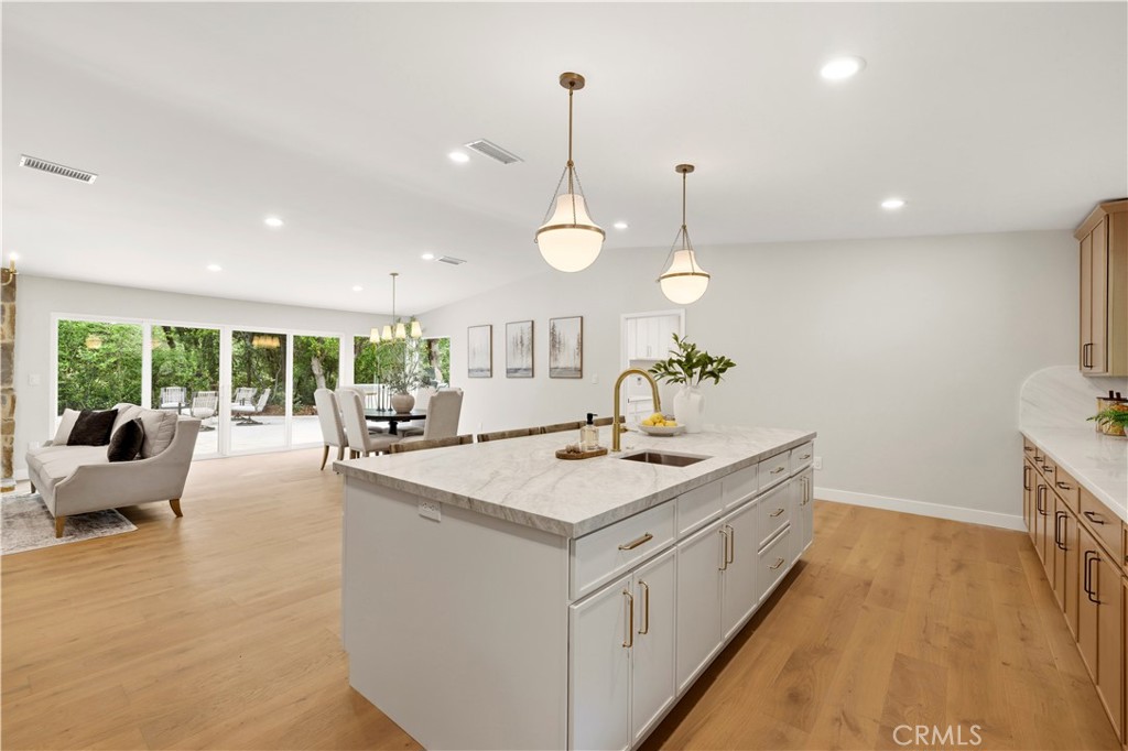 26418 Sand Canyon Road Canyon Country, CA 91387 - Photo 17 of 70 a large white kitchen with a large island oven a stove and a sink with large windows