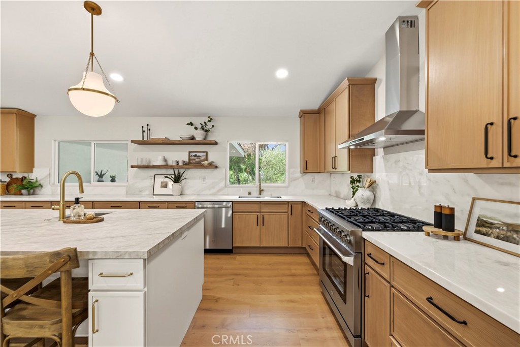 26418 Sand Canyon Road Canyon Country, CA 91387 - Photo 19 of 70 a kitchen with stainless steel appliances a sink stove and cabinets