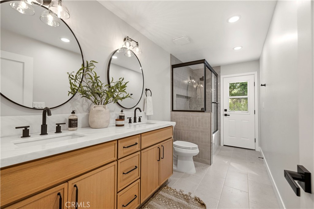 26418 Sand Canyon Road Canyon Country, CA 91387 - Photo 23 of 70 a bathroom with a double vanity sink mirror and toilet