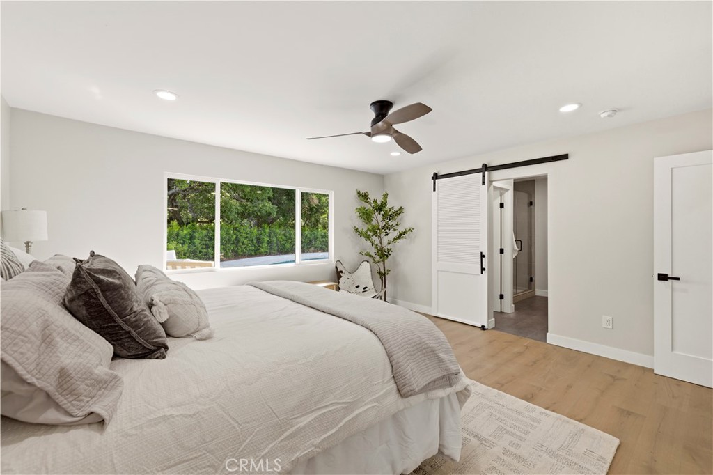 26418 Sand Canyon Road Canyon Country, CA 91387 - Photo 32 of 70 a bedroom with a large bed and a window