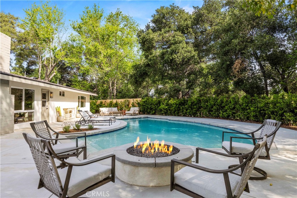 26418 Sand Canyon Road Canyon Country, CA 91387 - Photo 43 of 70 a view of a patio with dining table and chairs and potted plants