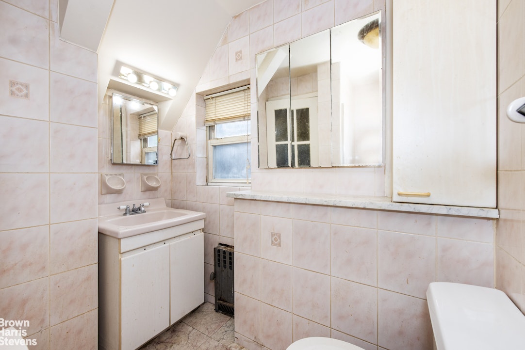 18-01 26th Road Queens, NY 11102 - Photo 10 of 16 a bathroom with a sink and a mirror