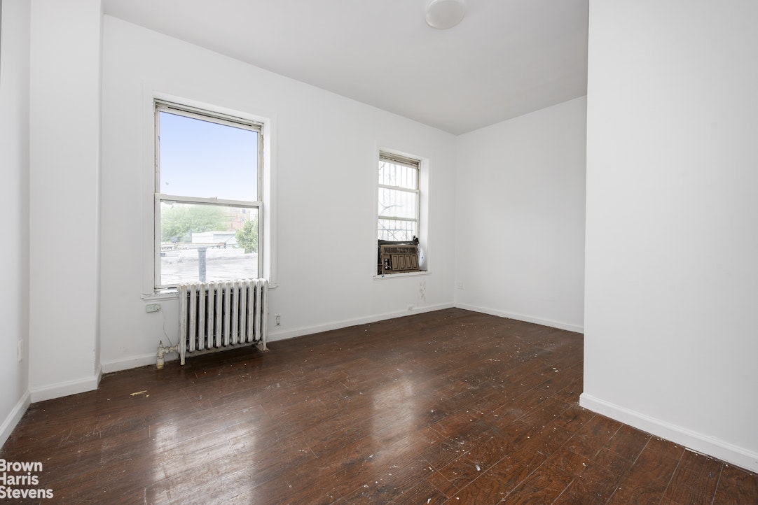 18-01 26th Road Queens, NY 11102 - Photo 11 of 16 an empty room with wooden floor and windows
