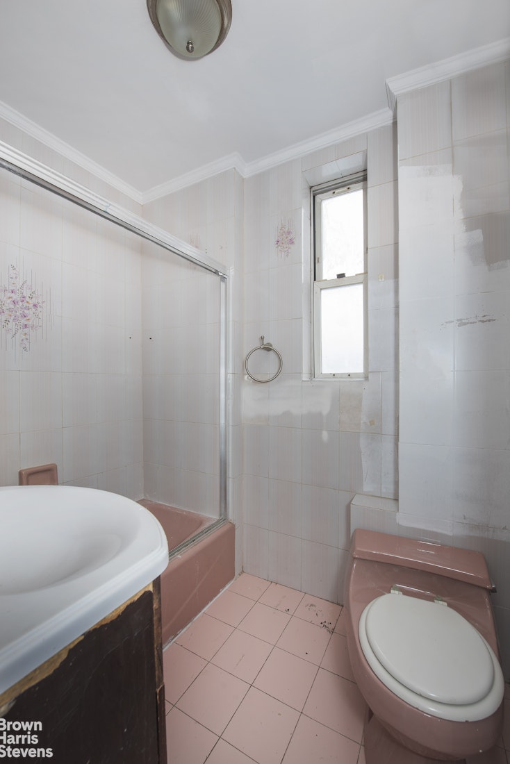 18-01 26th Road Queens, NY 11102 - Photo 13 of 16 a bathroom with a sink a toilet and a mirror