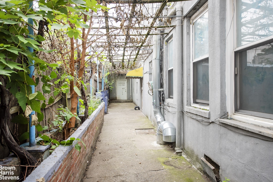 18-01 26th Road Queens, NY 11102 - Photo 6 of 16 a view of a pathway of a house with a yard