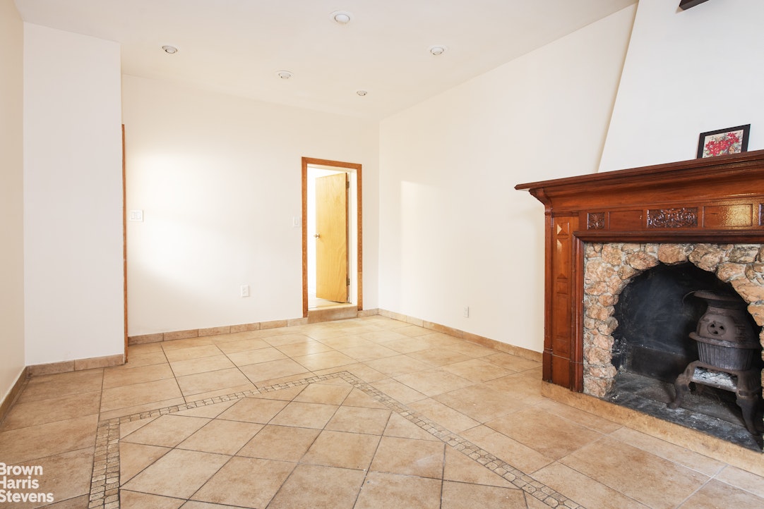 18-01 26th Road Queens, NY 11102 - Photo 8 of 16 a view of an empty room with a fireplace