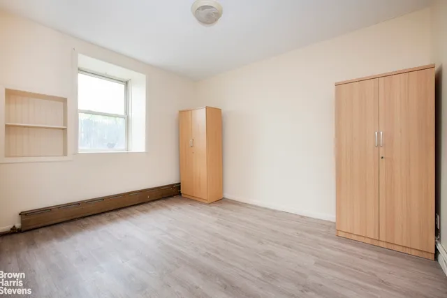 a view of an empty room with a fireplace