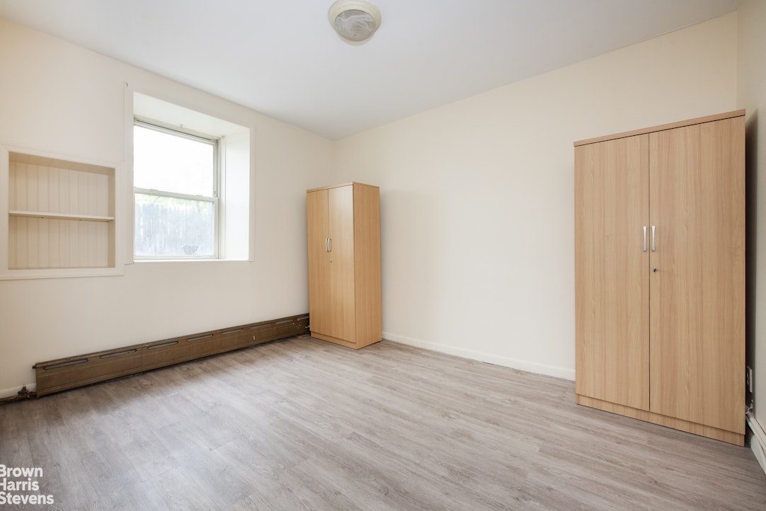 18-01 26th Road Queens, NY 11102 - Photo 9 of 16 an empty room with wooden floor and windows
