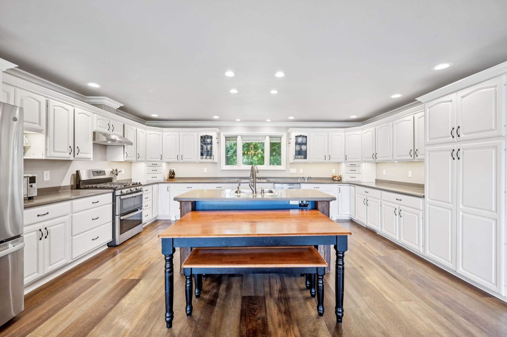 2797 Lewis Road Santa Fe, TN 38482 - Photo 19 of 92 a kitchen with stainless steel appliances kitchen island granite countertop white cabinets and wooden floors