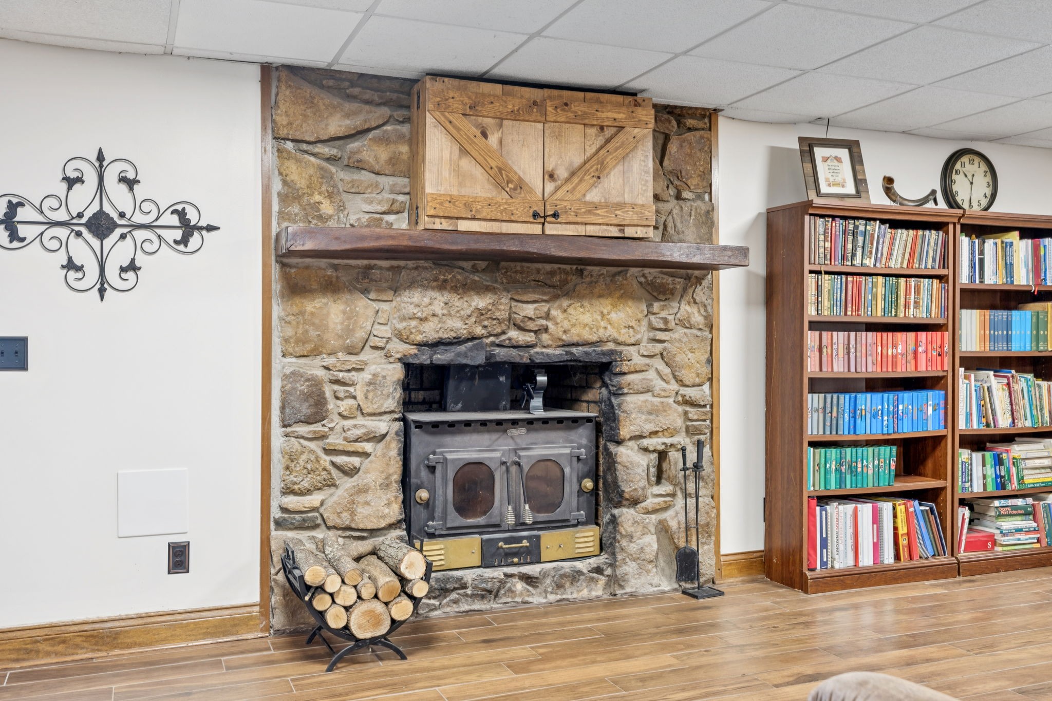 2797 Lewis Road Santa Fe, TN 38482 - Photo 38 of 92 a living room with a fireplace and a book shelf