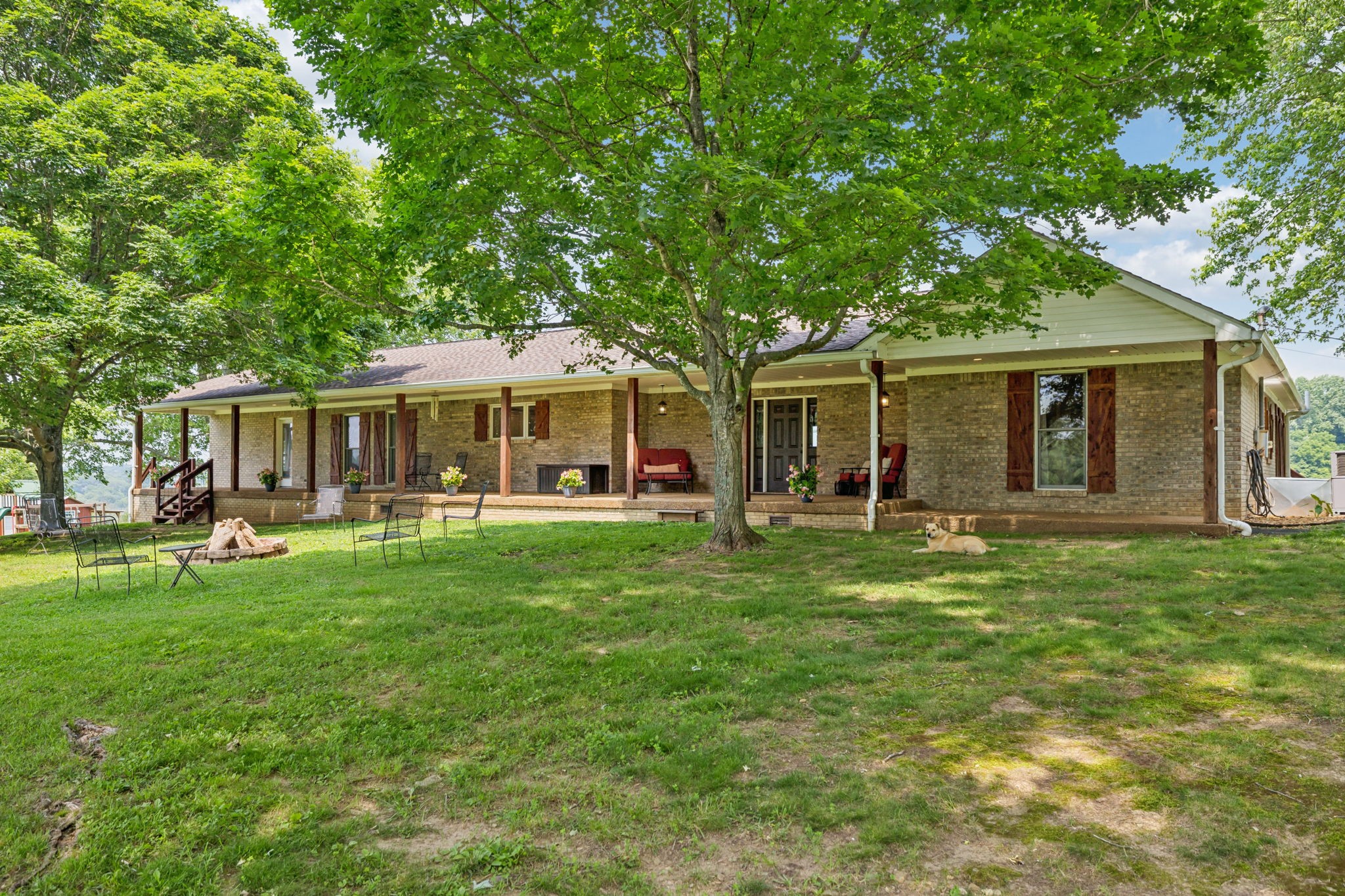 2797 Lewis Road Santa Fe, TN 38482 - Photo 4 of 92 a front view of a house with a garden and porch