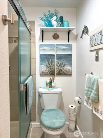 a bathroom with a toilet a sink and mirror