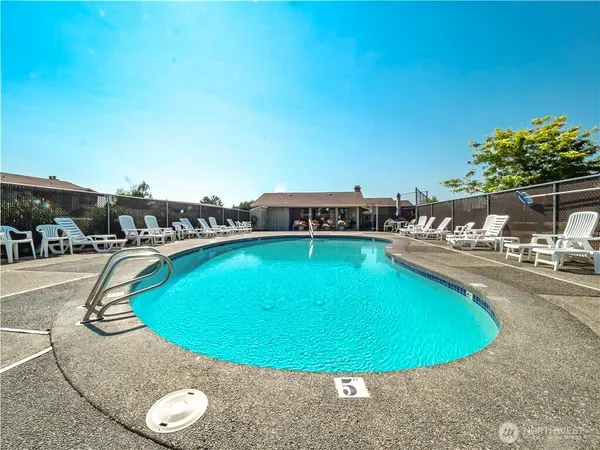 a view of a swimming pool with outdoor seating