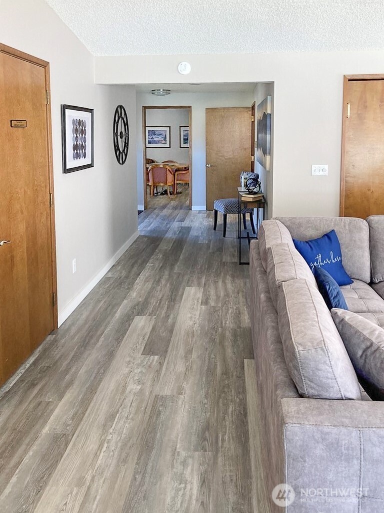 3390 Narrows Lane Northeast, Unit 101 Bremerton, WA 98310 - Photo 26 of 29 a living room with furniture and wooden floor