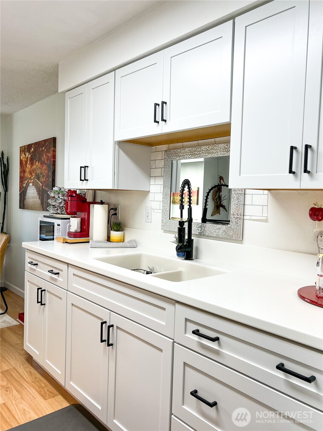 3390 Narrows Lane Northeast, Unit 101 Bremerton, WA 98310 - Photo 4 of 29 a kitchen with white cabinets and sink