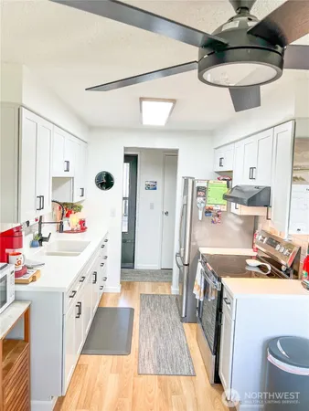 a kitchen with a sink a refrigerator and a stove