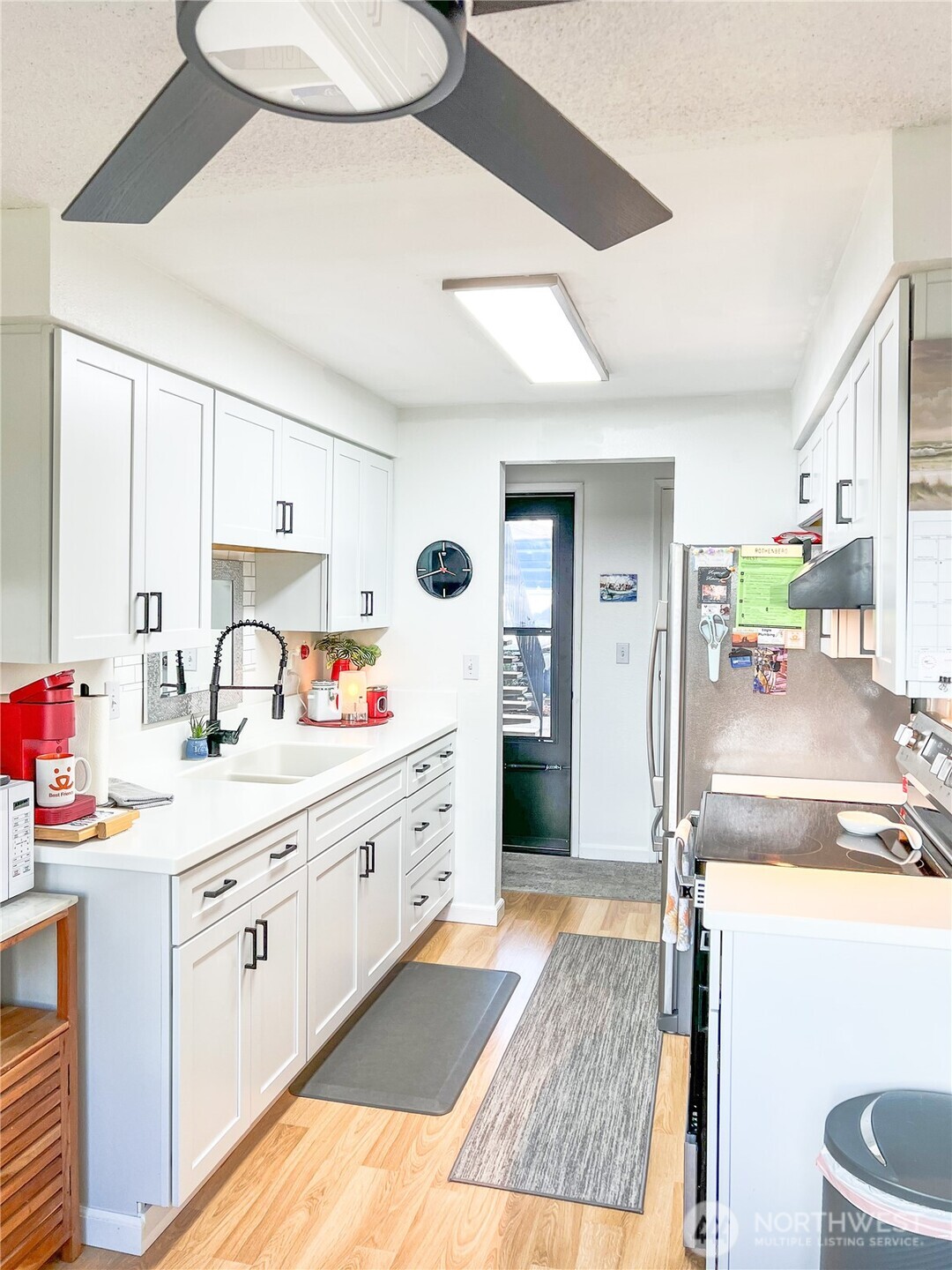 3390 Narrows Lane Northeast, Unit 101 Bremerton, WA 98310 - Photo 6 of 29 a large kitchen with a lot of counter space and wooden floor