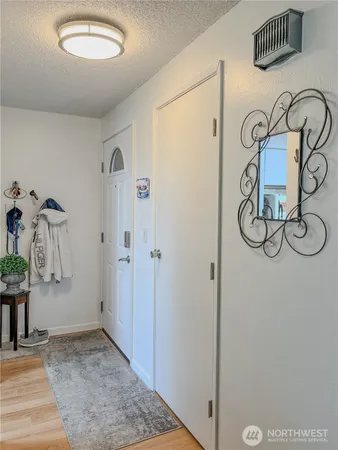a view of an entryway with wooden floor