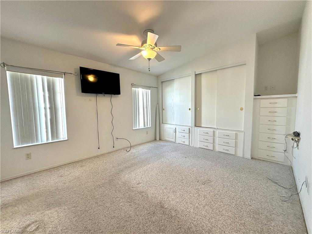 4551 Mayflower Way East Estero, FL 33928 - Photo 17 of 20 en empty room with windows and ceiling fan