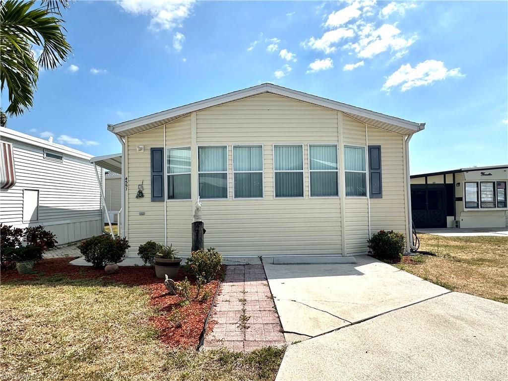 4551 Mayflower Way East Estero, FL 33928 - Photo 2 of 20 a view of a house with a yard