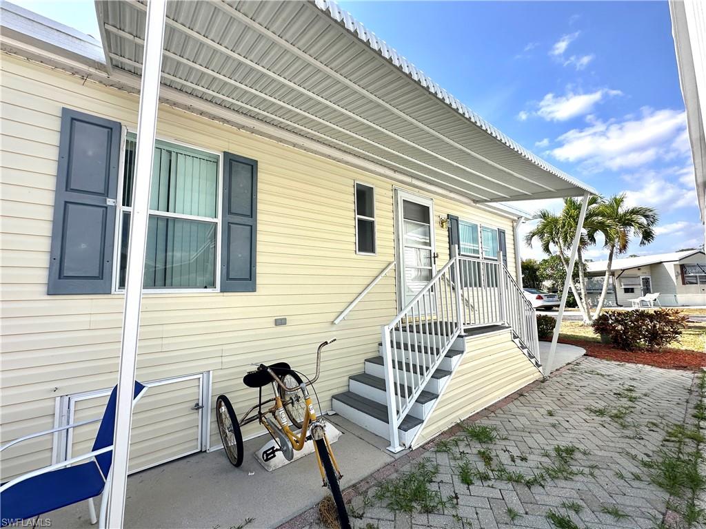 4551 Mayflower Way East Estero, FL 33928 - Photo 4 of 20 a view of a chair and tables in the patio