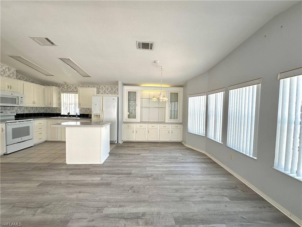 4551 Mayflower Way East Estero, FL 33928 - Photo 7 of 20 a view of a kitchen with microwave and stove top oven