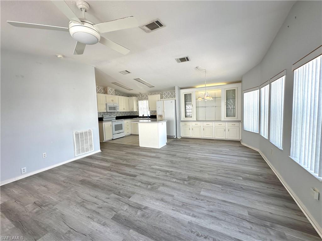 4551 Mayflower Way East Estero, FL 33928 - Photo 8 of 20 a view of a kitchen with a sink and wooden floor
