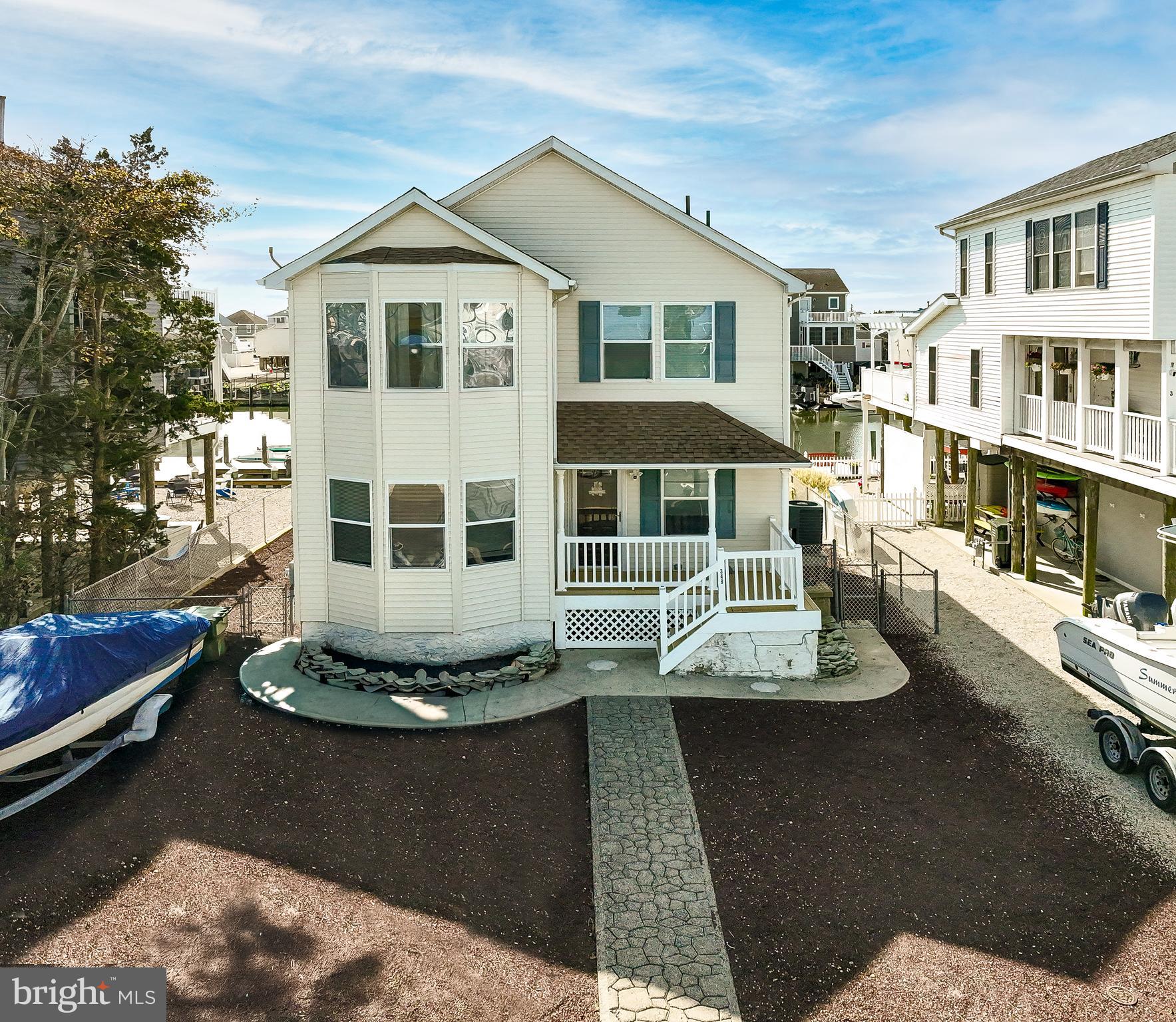 348 Kingfisher Road Tuckerton, NJ 08087 - Photo 1 of 37 a front view of a house with a yard fire pit and outdoor seating