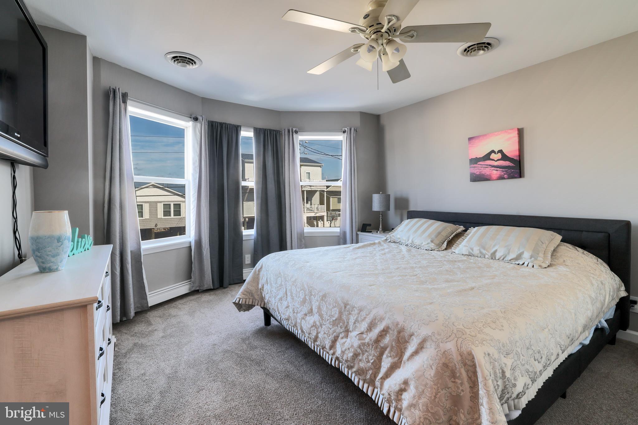 348 Kingfisher Road Tuckerton, NJ 08087 - Photo 17 of 37 a spacious bedroom with a bed and a chandelier