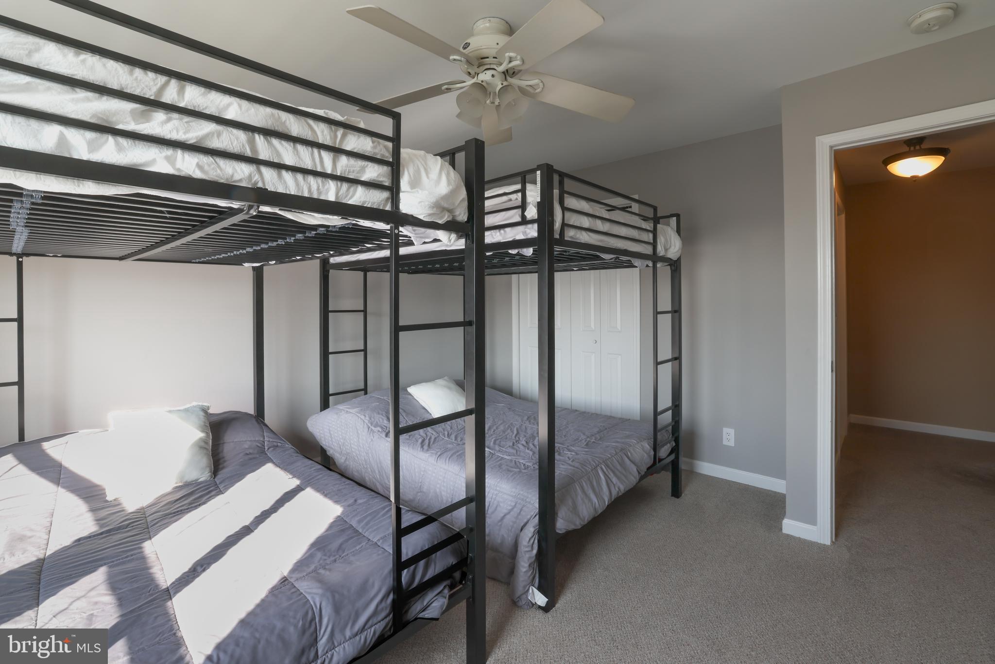 348 Kingfisher Road Tuckerton, NJ 08087 - Photo 20 of 37 a bedroom with a bed and a chandelier