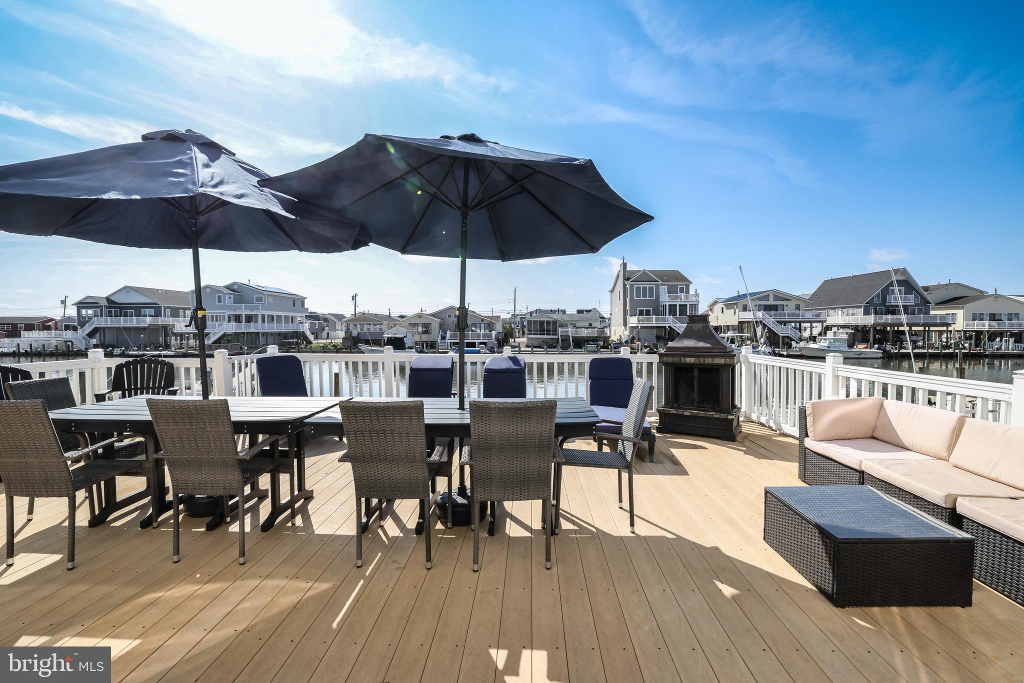 348 Kingfisher Road Tuckerton, NJ 08087 - Photo 29 of 37 a view of a roof deck with table and chairs under an umbrella