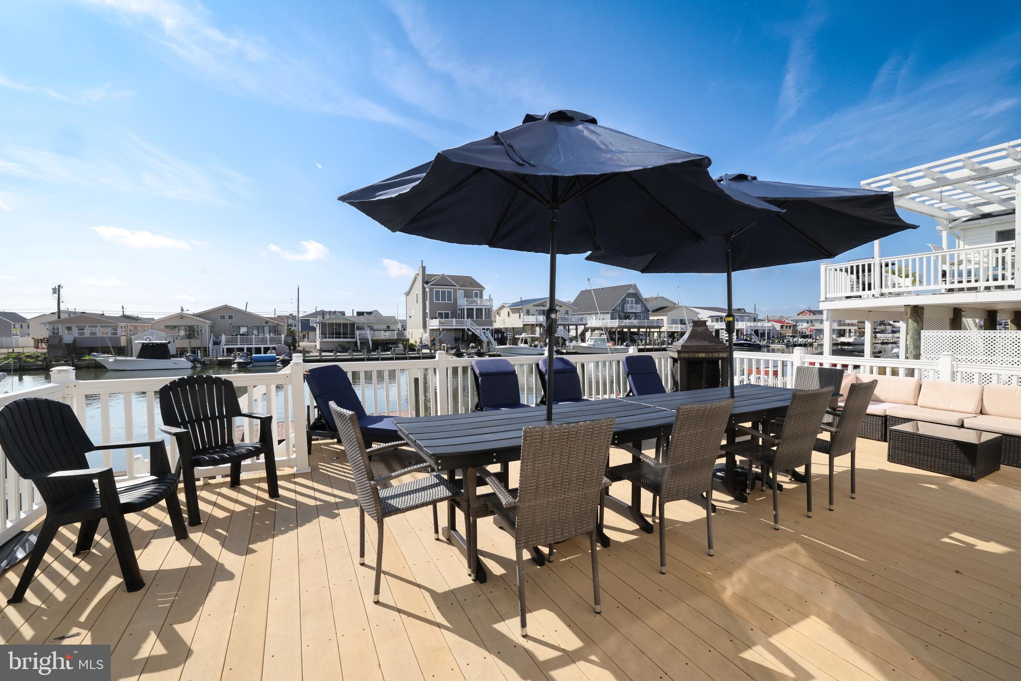 348 Kingfisher Road Tuckerton, NJ 08087 - Photo 31 of 37 a view of a roof deck with table and chairs under an umbrella