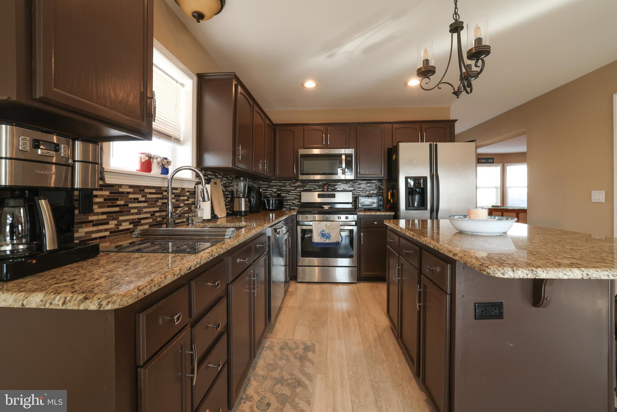 348 Kingfisher Road Tuckerton, NJ 08087 - Photo 5 of 37 a kitchen with stainless steel appliances granite countertop a sink a stove and a refrigerator