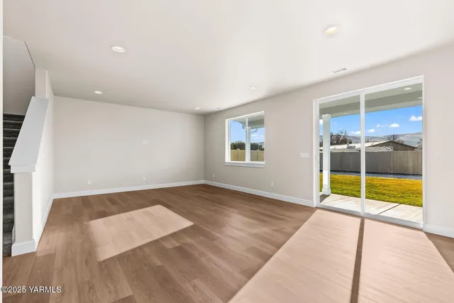 an empty room with floor to ceiling windows