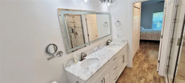 a bathroom with a granite countertop sink and a mirror