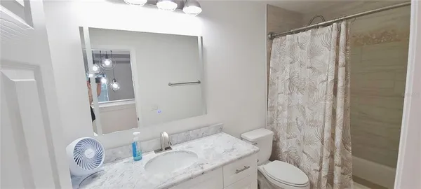 a white toilet sitting next to a bathroom sink