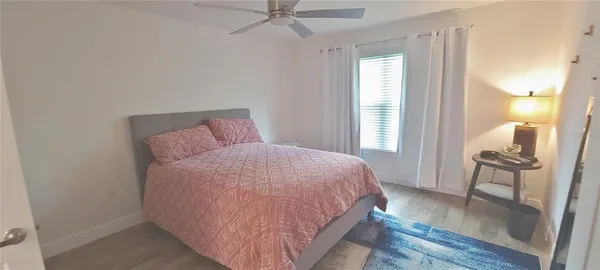 a bed room with a bed and a mirror