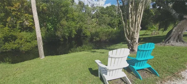 a backyard of a house with table and chairs
