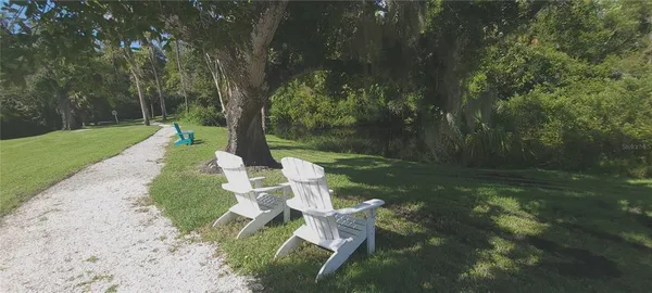 a swimming pool with outdoor seating and yard