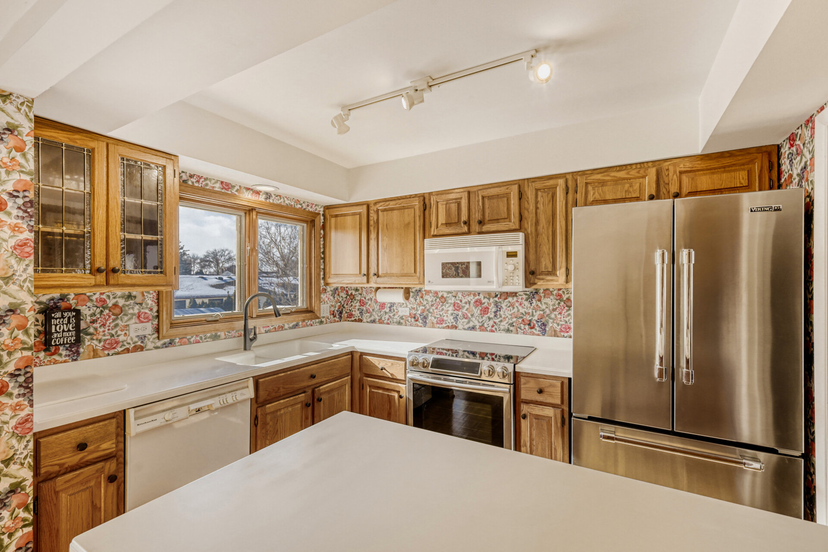 295 Brighton Road Elk Grove Village, IL 60007 - Photo 8 of 26 a kitchen with a sink stainless steel appliances cabinets and a counter top space