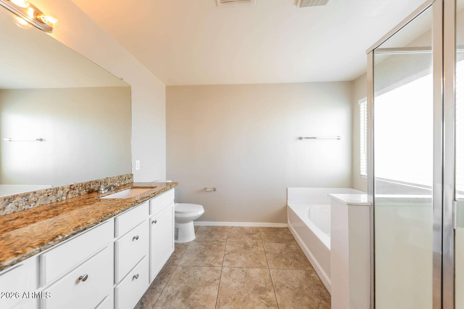 6716 South 36th Lane Phoenix, AZ 85041 - Photo 12 of 22 a bathroom with a granite countertop sink toilet and shower